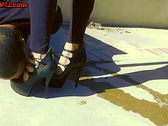 Femdom redhead wanks black cock outdoor after heels licking