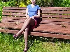 Sunny But Windy Day In May 2020. A Bench In A Garden