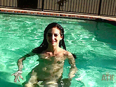 Beauty babe enjoys on swimming pool