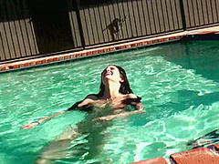 Beauty babe enjoys on swimming pool