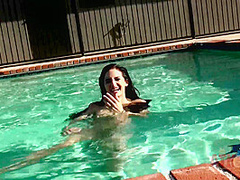 Beauty babe enjoys on swimming pool