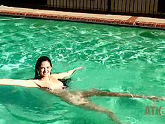 Beauty babe enjoys on swimming pool