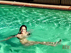 Beauty babe enjoys on swimming pool